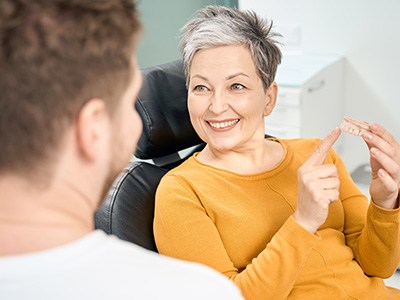 a patient speaking with her dentist about getting a crown