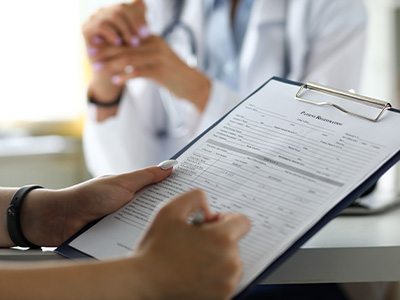 a patient filling out dental forms