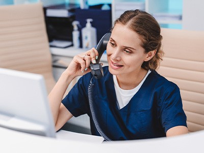 a front office staff speaking with a patient on the phone