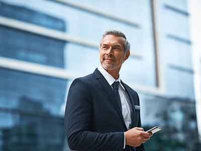 a businessman in a suit with his phone in his hand