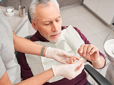 Man getting dentures at the dentist