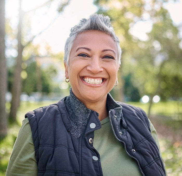 Senior woman standing outside and smiling