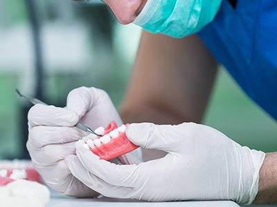 Dental lab technician working on a denture in Buda, TX